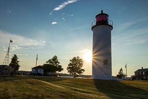 Beaver Island light house with sun setting behind